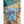 Load image into Gallery viewer, summer-mockup-of-an-ai-created-t-shirt-placed-next-to-a-pool-m40681