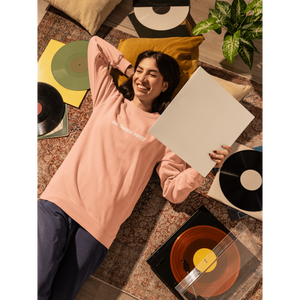 comfort-colors-sweatshirt-mockup-of-a-smiling-woman-lying-on-the-floor-with-a-vinyl-m56620